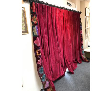 A pair of crimson velvet curtains with patchwork borders and tie backs by Julia Trevelyan Oman, 213cm x 305cm and the pole CO