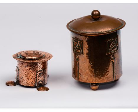 Arts & Crafts movement/A hammered copper inkwell, in the manner of F & J Pool of Hayle, Cornwall, on three shaped feet, with 