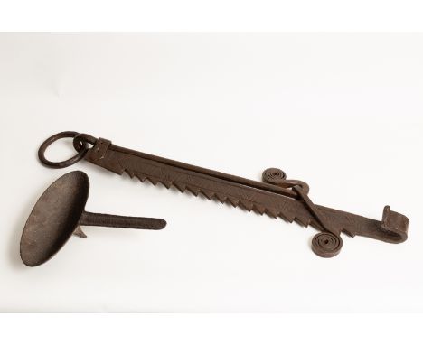A wrought iron pot hook with ratchet support, 73cm high and an oval wrought iron ladle