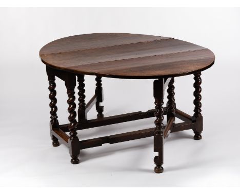 A late 17th Century oak gate-leg table, with two flap oval top on spiral turned columns and gates, united by square stretcher