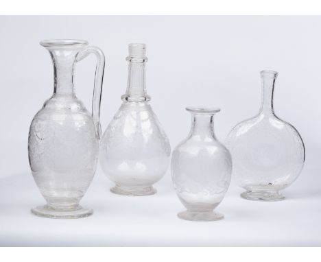 A group of English engraved glassware, circa 1880, comprising a claret jug finely engraved swags and tendrils, 26.5cm high, a