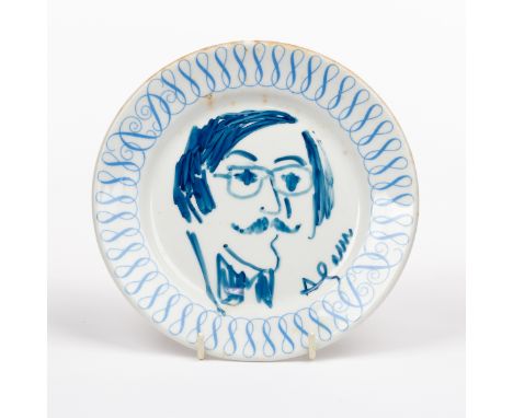 A plate decorated a portrait of Sir Roy Strong by Yaacov Agam with border of scrolls, 16.5cm diameter, contained in a marbled