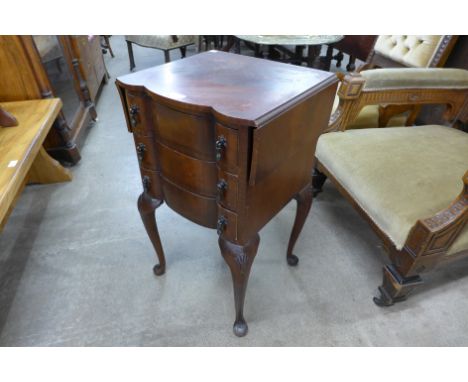 A small mahogany serpentine drop leaf chest of drawers 
