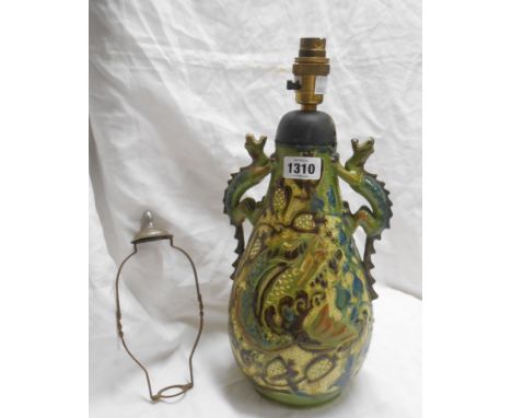An early 20th Century C.H. Brannam Barnstaple Art Pottery vase with incised grotesque fish decoration on a green glaze ground
