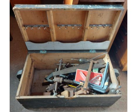 An old wooden toolbox containing tools