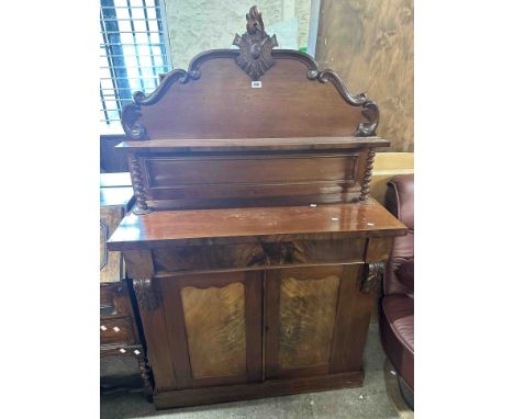 A 1.07m Victorian mahogany chiffonier with decorative carved raised back, blind frieze drawer and double panelled cupboard un