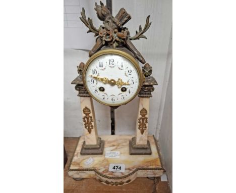 A late 19th Century portico mantel clock with bronze mounts to the marble uprights and base, decorated dial, Sol de Mayo pend