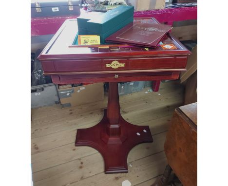 A vintage, as new, Franklin Mint Collector's Edition Monopoly game with gold plated playing pieces, set on a wooden stand and