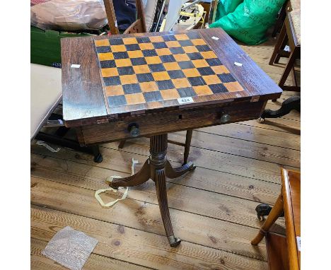 A 56cm 19th Century rosewood games table with reversible chessboard top and frieze drawer, set on reeded pillar and tripod ba