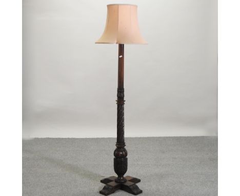 An early 20th century oak standard lamp and shade
