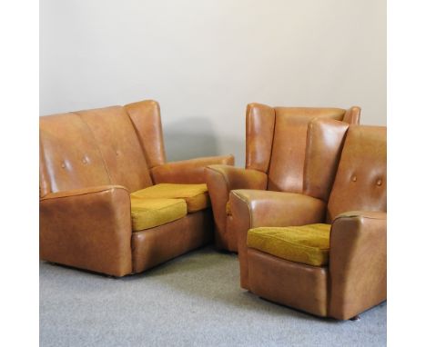 A mid 20th century tan upholstered three piece suite, comprising a sofa, 133cm, and two armchairs