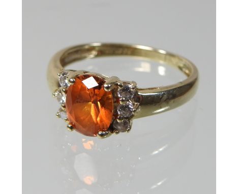 A 14 carat gold simulated fire opal and diamond ring, boxed