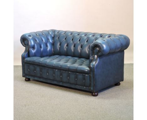 A blue upholstered button back chesterfield sofa, 150cm