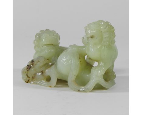 A jade coloured carving of dogs of Fo, 14cm