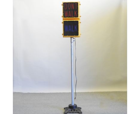 A vintage American walk/don't walk illuminated pedestrian crossing sign, on a later metal base, 217cm high overall