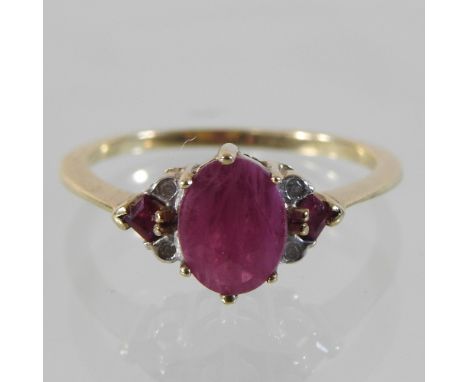 A 9 carat gold three stone ruby ring