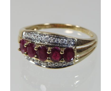 A 9 carat gold ruby and diamond eternity ring, boxed