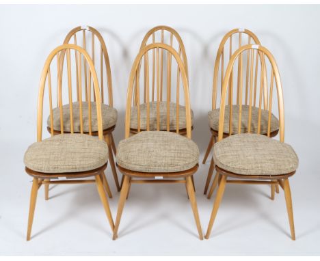 A SET OF SIX LIGHT ELM ERCOL SPINDLEBACK KITCHEN CHAIRS and an Ercol light elm drop leaf kitchen table, 107cm wide (7)