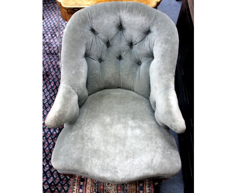 A HOWARD STYLE VICTORIAN BUTTON UPHOLSTERED LOW CHAIR, short wing arms, serpentine fronted seat, standing on ring turned tape