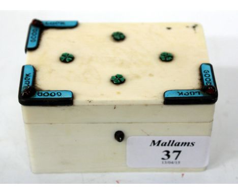 A SMALL IVORY ENAMEL AND SEMI PRECIOUS STONE DECORATED BOX the top inset with green enamelled four leafed clovers, the corner