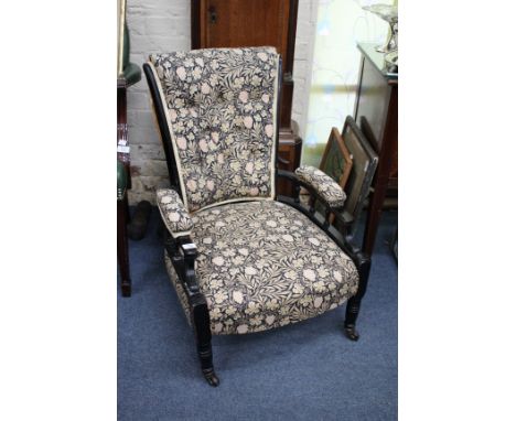 A VICTORIAN EBONISED AESTHETIC ARMCHAIR button upholstered back, pad upholstered arms, columned support, on turned tapering f