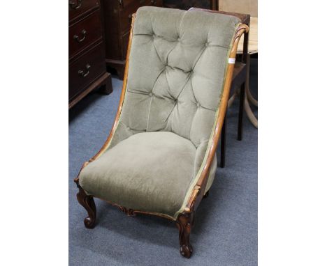 A VICTORIAN MAHOGANY BUTTON BACKED SLIPPER CHAIR with scroll carved frame and cabriole legs, 53cm wide