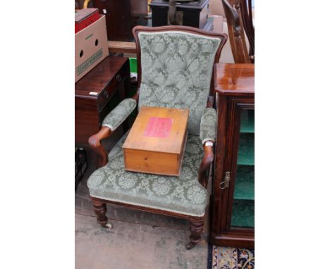 AN EDWARDIAN MAHOGANY OPEN ARMCHAIR with button upholstered back and overstuffed upholstered seat and standing on turned tape