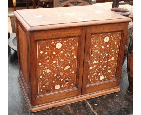 AN EARLY 20th CENTURY MAHOGANY CABINET, with two panelled doors, bone and mother of pearl inlaid decoration, 52cm wide 