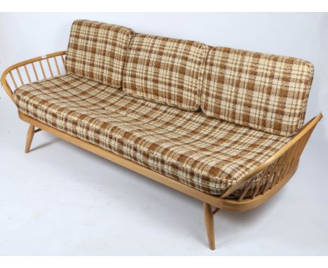 AN ERCOL LIGHT ELM DAY BED, single plank back, spindle supported sides, 212cm wide together with two Ercol lounge chairs (3)
