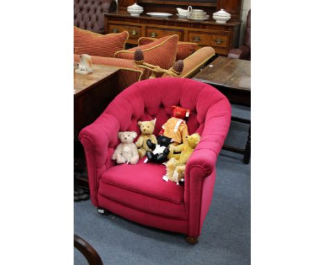 A HORSESHOE SHAPED BUTTON UPHOLSTERED LOW OCCASIONAL CHAIR with turned front feet 78cm wide together with a further similar s