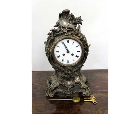 A CONTINENTAL MANTLE CLOCK the silvered acanthus leaf scrolling case with white enamel dial with black Roman numerals, the mo