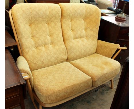 AN ERCOL LIGHT ELM SPINDLEBACK TWO SEATER SETTEE, 142cm wide