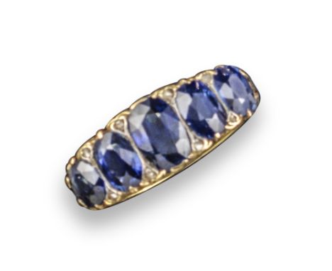 A 19th century sapphire five-stone ring, the graduated oval-shaped sapphires set with diamond pointers in carved and pierced 