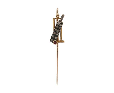 A ruby and diamond stick pin, depicting a cricket bat set overall with diamonds, a ruby ball and gold stumps, suspended from 