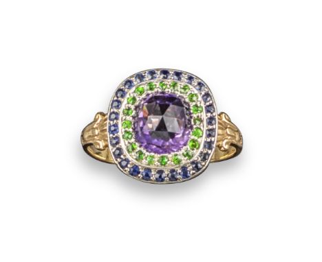 A gem-set cluster ring, centred with a faceted amethyst within a surround of circular-cut green garnets and sapphires, with f