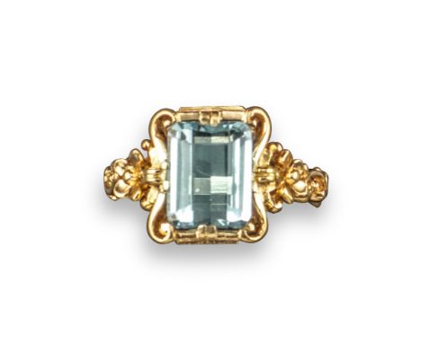 An aquamarine set ring, the rectangular step-cut aquamarine set within foliate scrolling yellow gold mount, size P