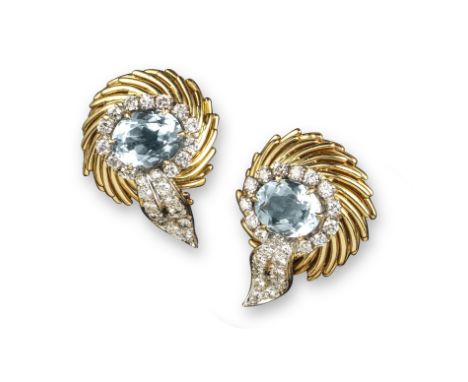 A pair of aquamarine and diamond scroll earrings, set with an oval-shaped aquamarine within a surround of diamonds and a diam