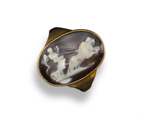 A late 17th / early 18th century sardonyx cameo ring depicting a winged Eros riding a chariot pulled by two lions, in a gold 