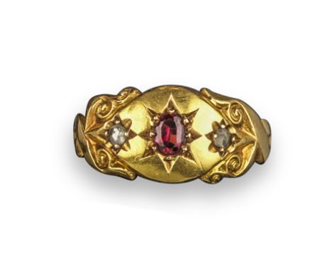 An early 20th century gem-set gypsy ring, set with an oval-shaped red doublet and rose-cut diamonds in a carved scroll gold m
