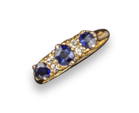 A Victorian sapphire and diamond half hoop ring, set with graduated cushion-shaped sapphires and four diamonds in carved and 