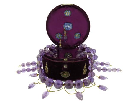A velvet cylindrical box mounted with ten pertabghars, with polychrome enamel to their reverses, containing a large graduated