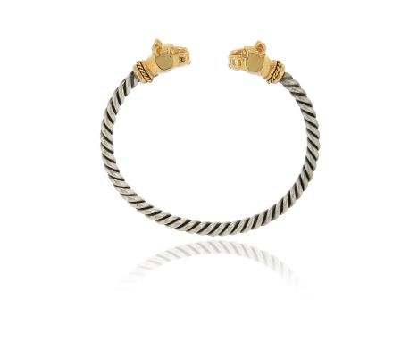 A silver and gold panther's head bangle, with twisted silver gold bangle and stylised gold panther's head terminals, 6cm inne