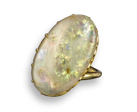 An opal single stone ring, the large solid white opal is claw-set in yellow gold, size L 1/2