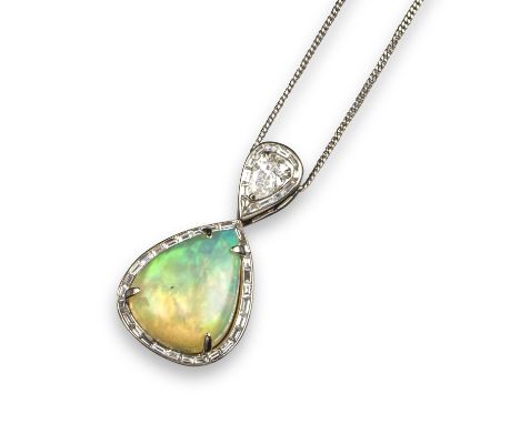 An opal and diamond pendant, the pear-shaped cabochon opal is set within a border of baguette-shaped diamonds, suspended from