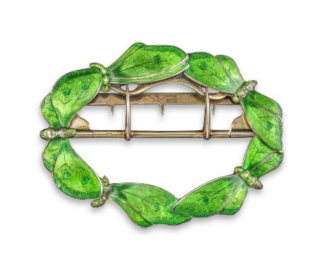 A silver and enamel belt buckle by Child &amp; Child, formed as interlocking butterflies decorated with green enamel in silve