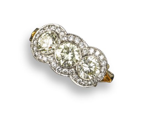 A diamond triple cluster ring, each round brilliant-cut diamond is set within a surround of further circular-cut diamonds, wi