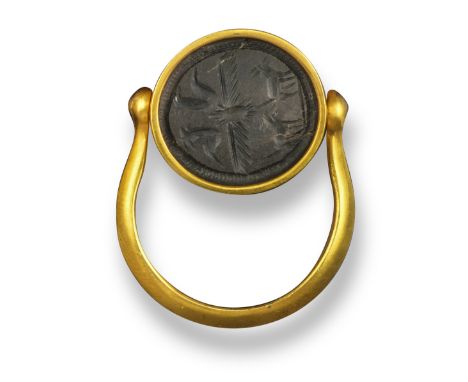 A black jasper scarab, probably Ancient, the underside carved with a winged scarab and other creatures, 1.3cm long, in a late