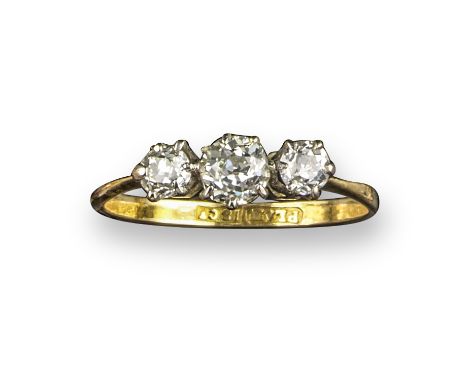 A diamond three-stone ring, set with three old circular-cut diamonds in platinum and gold, size N