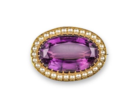 A Victorian seed pearl and amethyst gold brooch, the oval-shaped amethyst set within a surround of seed pearls in yellow gold