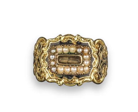 A 19th century gold mourning ring, set with seed pearls, with black enamel decoration and foliate engraved scroll shoulders i